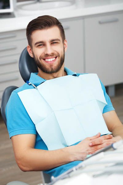 patient smiling during his cosmetic dentistry appointment at Sandia View Family Dental