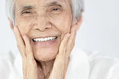 woman loving her restored smile thanks to dental implants from Sandia View Family Dental