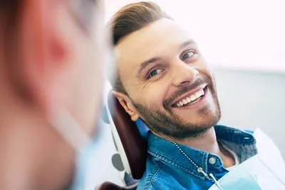 man smiling during his dental appointment at Sandia View Family Dental
