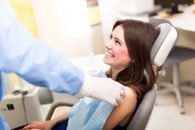 woman smiling during her visit to Sandia View Family Dental