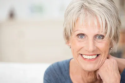 woman smiling with her new dental implants from Sandia View Family Dental